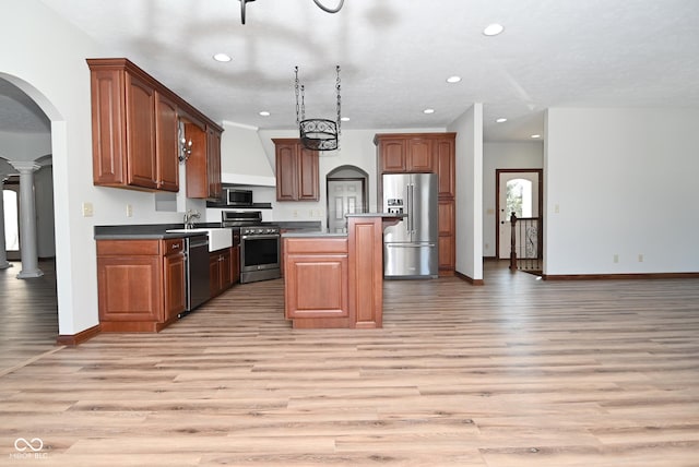 kitchen with sink, a center island, light hardwood / wood-style floors, stainless steel appliances, and custom range hood