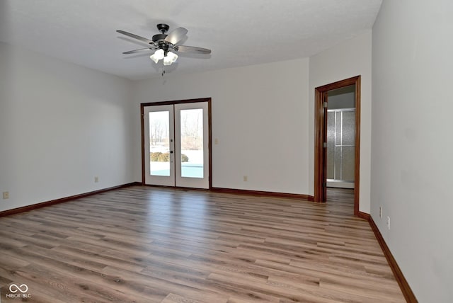 spare room with ceiling fan, light hardwood / wood-style floors, and french doors