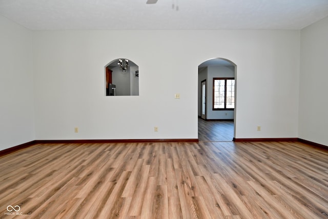 spare room featuring ceiling fan and light wood-type flooring