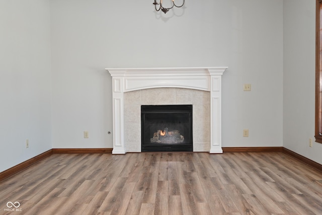 room details with hardwood / wood-style floors and a tile fireplace