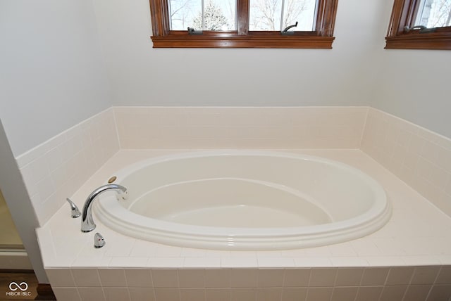 bathroom with a relaxing tiled tub