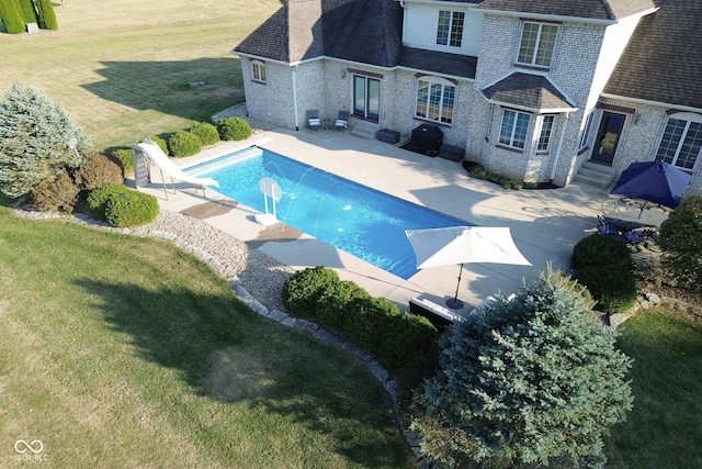 view of pool with a yard, a patio area, and a water slide