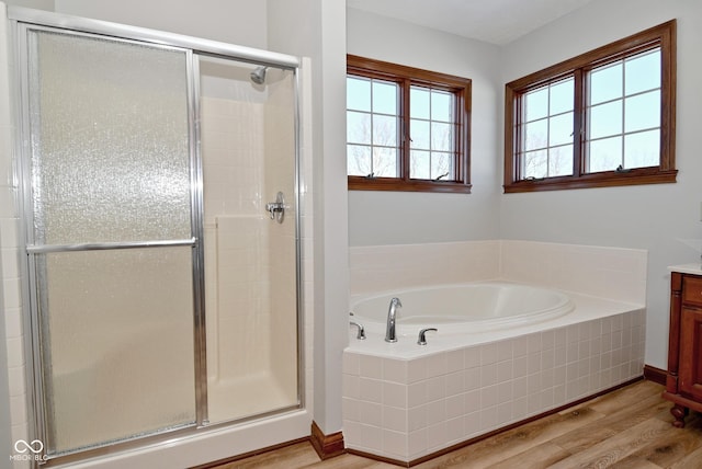 bathroom with vanity, hardwood / wood-style flooring, and independent shower and bath