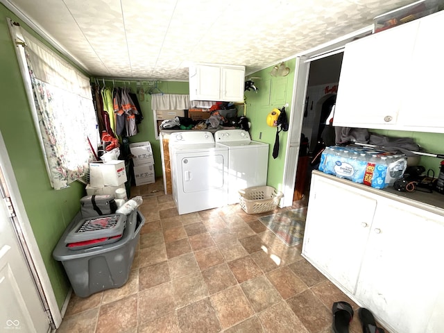 washroom featuring cabinets and washer and dryer