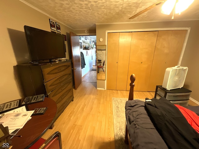 bedroom featuring a closet, ornamental molding, and light hardwood / wood-style flooring