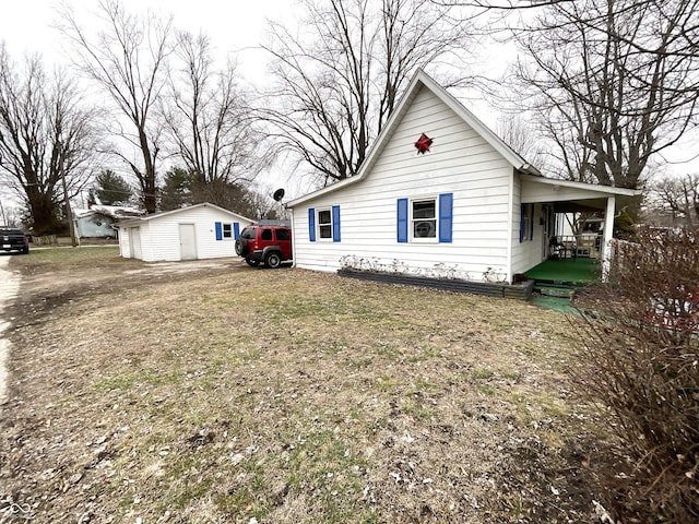 view of side of home with an outdoor structure and a lawn