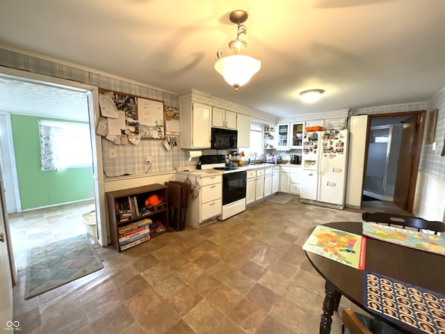 kitchen featuring white refrigerator, sink, white cabinets, and electric stove