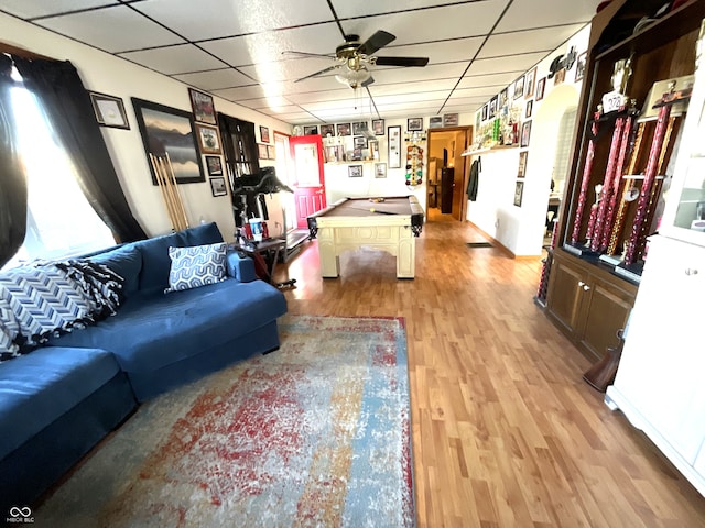 living room featuring a drop ceiling, light hardwood / wood-style flooring, billiards, and ceiling fan