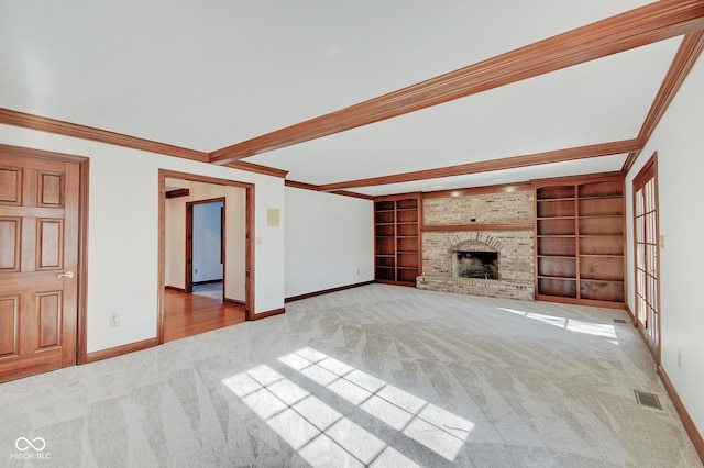 unfurnished living room featuring built in features, beam ceiling, ornamental molding, light carpet, and a brick fireplace