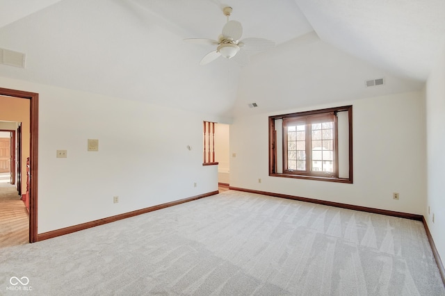 spare room with ceiling fan, light colored carpet, and high vaulted ceiling