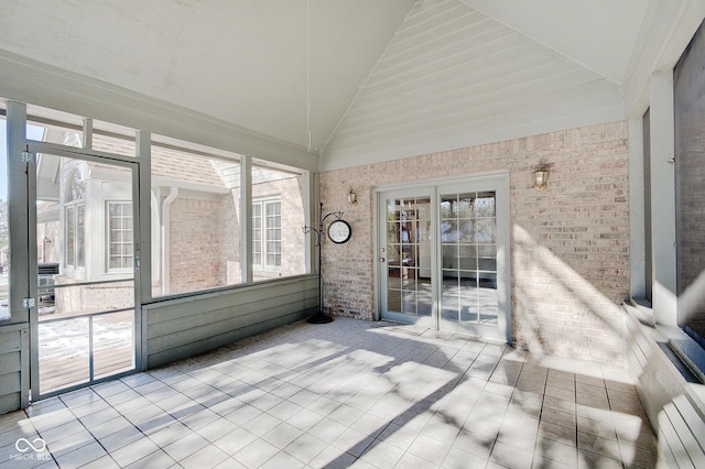 unfurnished sunroom featuring lofted ceiling