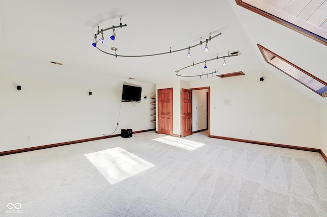 unfurnished living room with light colored carpet and a skylight