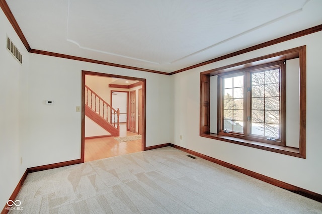 carpeted spare room with crown molding