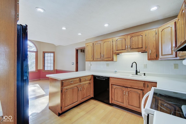 kitchen with white electric range, sink, light hardwood / wood-style flooring, dishwasher, and kitchen peninsula