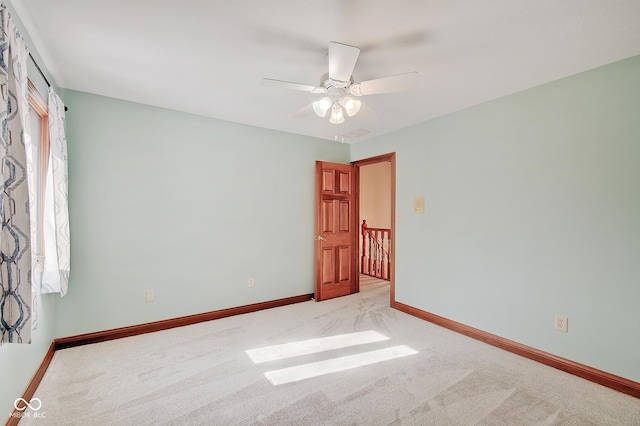 empty room with light carpet and ceiling fan