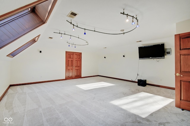 unfurnished living room featuring lofted ceiling and light colored carpet