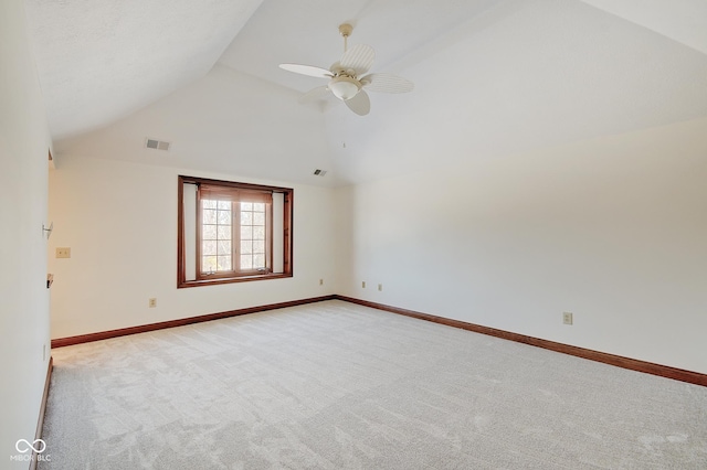 carpeted empty room with ceiling fan and vaulted ceiling