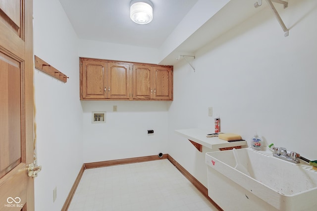 washroom featuring cabinets, hookup for a washing machine, and sink