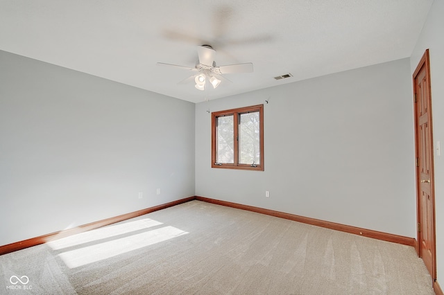 carpeted spare room with ceiling fan