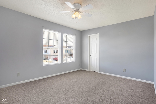 spare room with ceiling fan, carpet flooring, and a textured ceiling