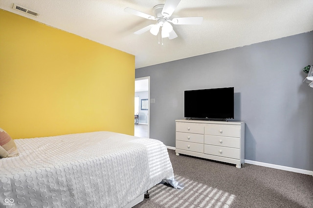 carpeted bedroom with a textured ceiling and ceiling fan