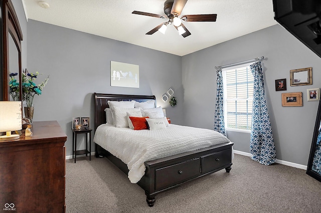 bedroom featuring a textured ceiling, ceiling fan, and carpet