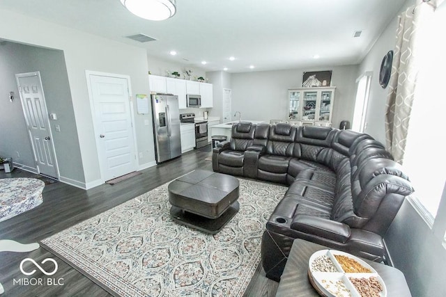 living room with dark hardwood / wood-style flooring