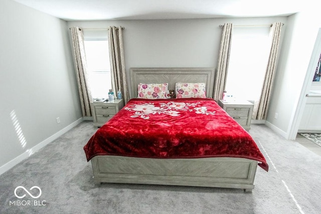 bedroom with light carpet and ensuite bath