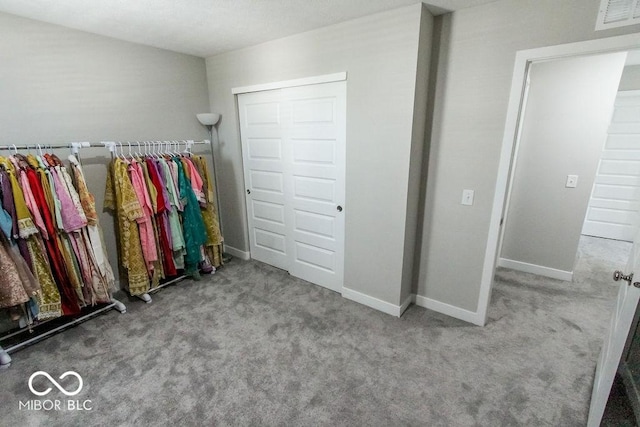 unfurnished bedroom with light carpet and a closet