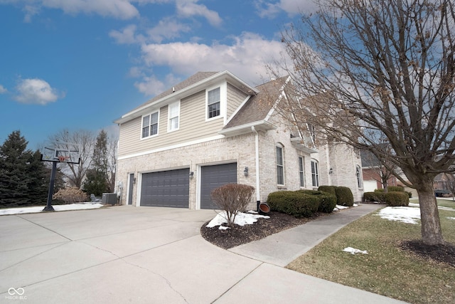 view of property exterior featuring a garage and central air condition unit