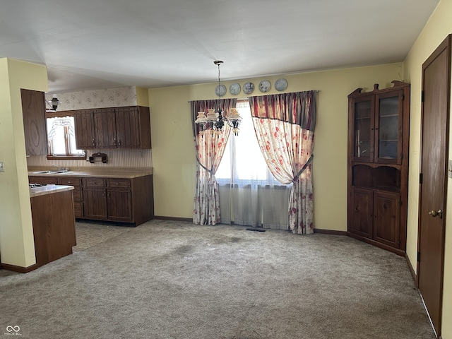 unfurnished dining area with light carpet