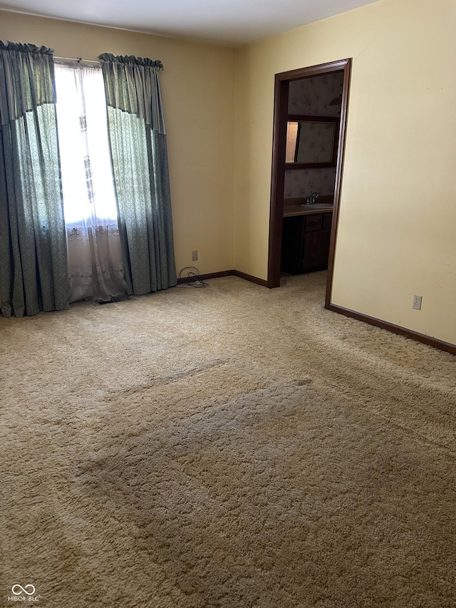 carpeted spare room featuring sink