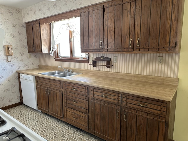 kitchen featuring white dishwasher, sink, and dark brown cabinets