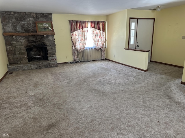 unfurnished living room featuring carpet floors and a fireplace