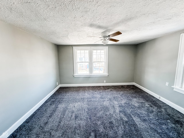 carpeted empty room featuring ceiling fan and a textured ceiling