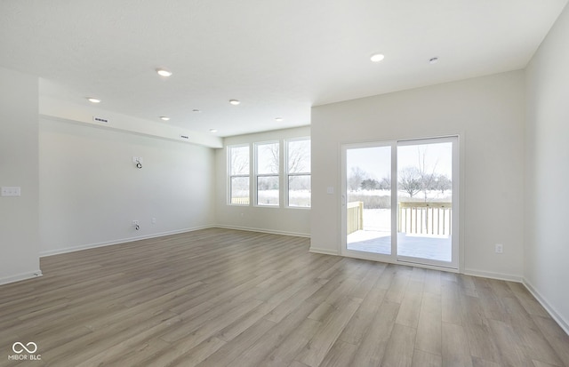 empty room with light hardwood / wood-style flooring