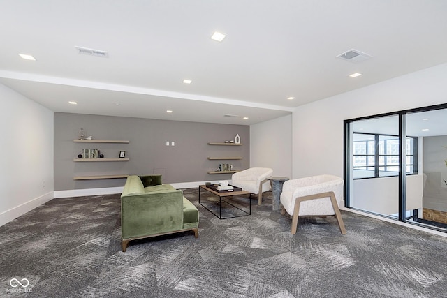 sitting room featuring dark carpet