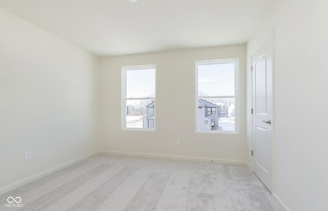 unfurnished room featuring light carpet