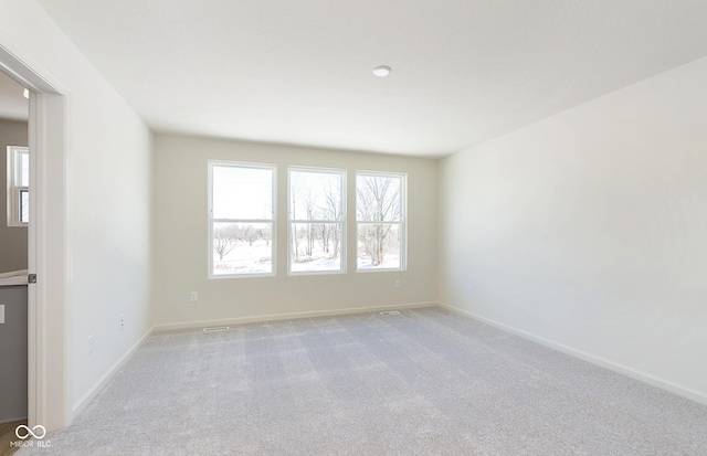 unfurnished room with light colored carpet