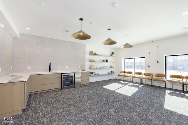 kitchen featuring light brown cabinetry, sink, beverage cooler, decorative backsplash, and dark carpet