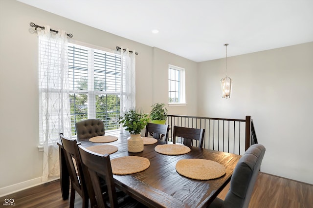 dining space featuring an inviting chandelier and dark hardwood / wood-style floors