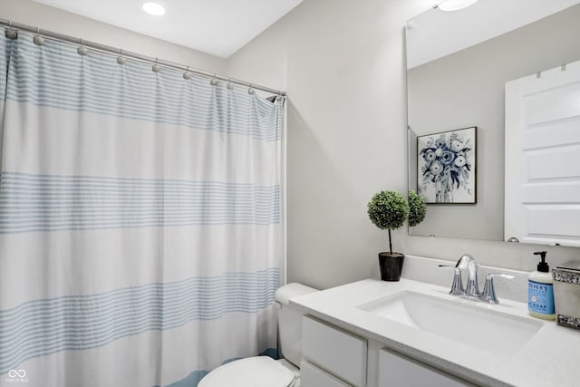 bathroom featuring vanity, toilet, and curtained shower