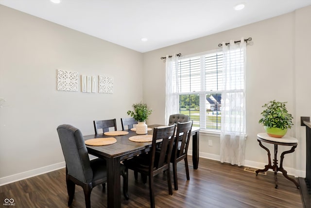 dining space featuring a healthy amount of sunlight and dark wood-type flooring