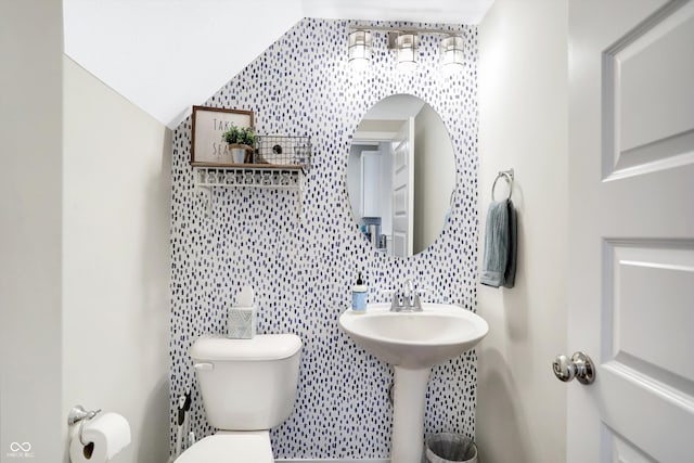 bathroom featuring vaulted ceiling and toilet