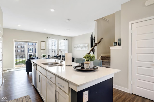 kitchen featuring sink, dark hardwood / wood-style floors, dishwasher, an island with sink, and white cabinets