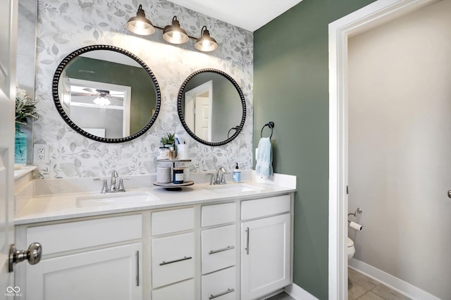 bathroom featuring ceiling fan, vanity, toilet, and tile patterned flooring