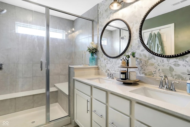 bathroom with vanity and a shower with shower door