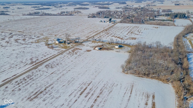 snowy aerial view featuring a rural view