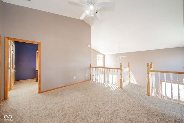 carpeted empty room with ceiling fan and lofted ceiling