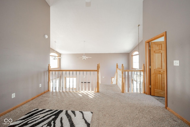 hall with vaulted ceiling and carpet